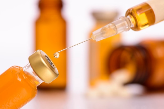 Photo close-up of syringe at table