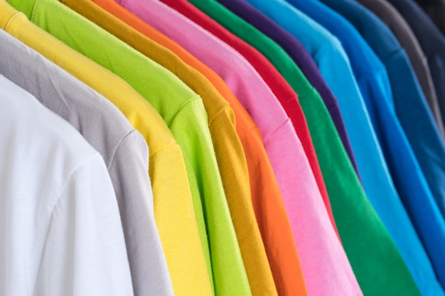 Premium Photo | Close up of colorful t-shirts on hangers