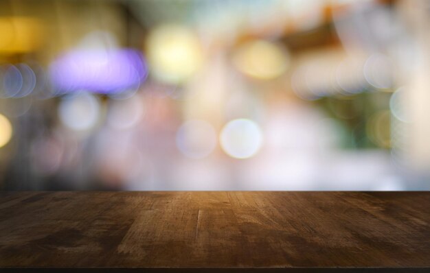 Close-up of table against defocused image of illuminated lights at night