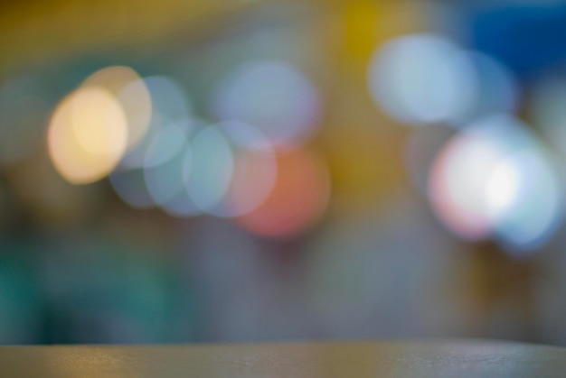 Photo close-up of table against illuminated colorful lights