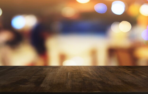 Photo close-up of table with illuminated lights in background