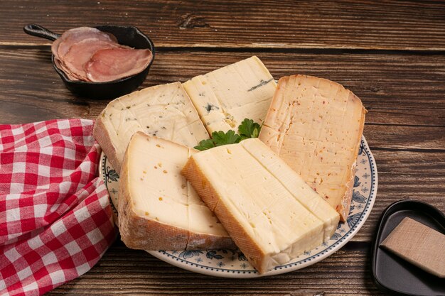 Close up of tasty cheese platter on a wooden table