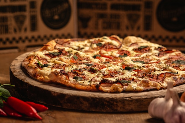 Foto primo piano di gustosa pizza su un tagliere di legno