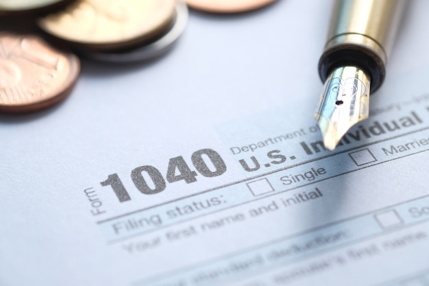 Close up of a Tax return form and pen on table.