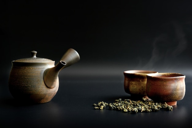 Close-up of tea cup on table against black background