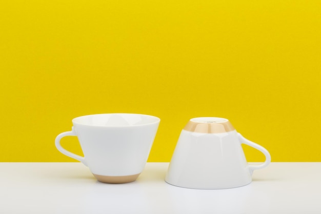 Close-up of tea cup on table against yellow background