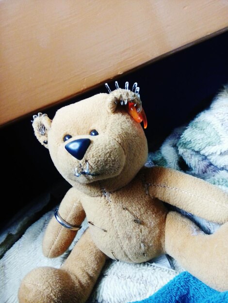 Close-up of teddy bear on bed at home