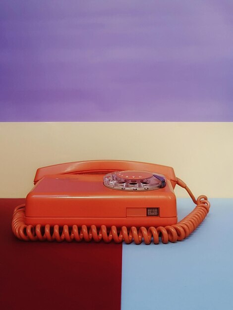 Photo close-up of telephone against colored background