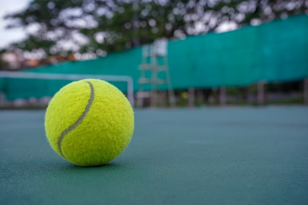 Close up tennis ball on the courts background.