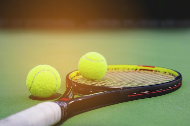 Close-up of tennis racket and balls on court