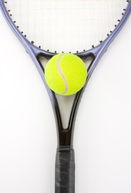 Close-up of tennis racket and yellow ball