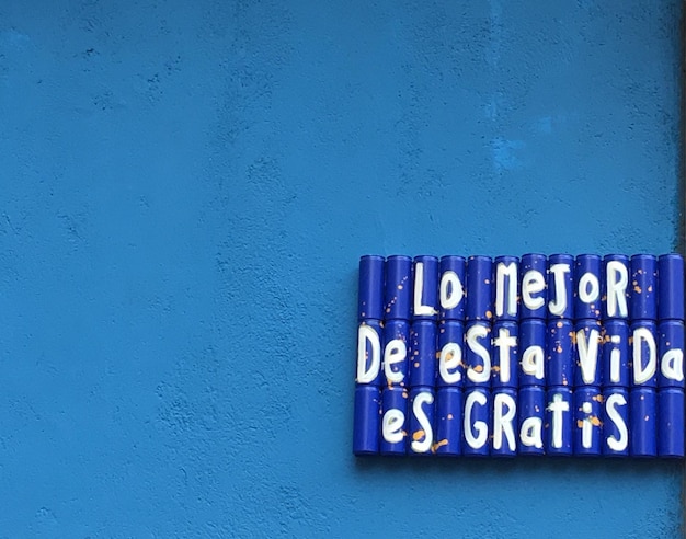 Photo close-up of text on blue wall