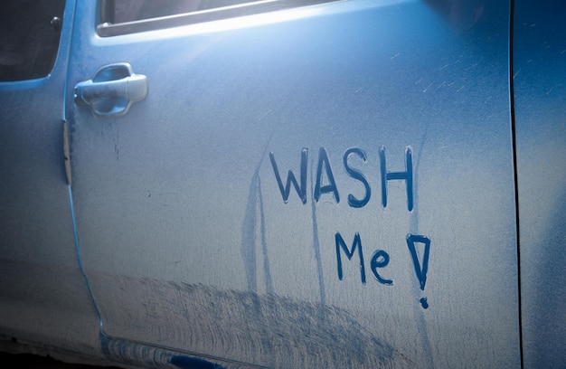 Photo close-up of text on dirty car