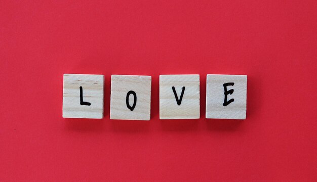 Close-up of text love on red wall