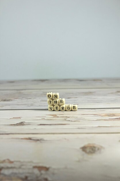 Photo close-up of text on table by sea against clear sky