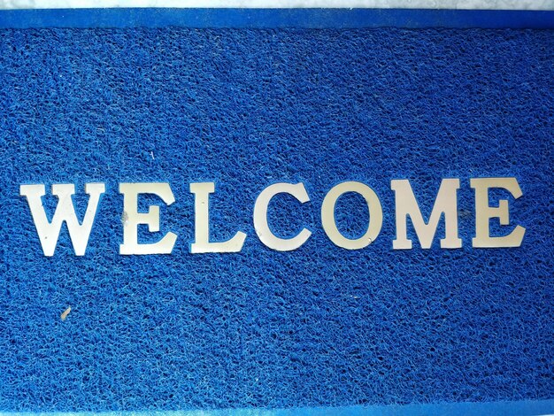 Photo close-up of text on welcome mat