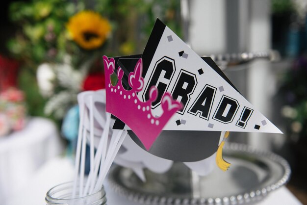 Close-up of text on white flower on table grad party