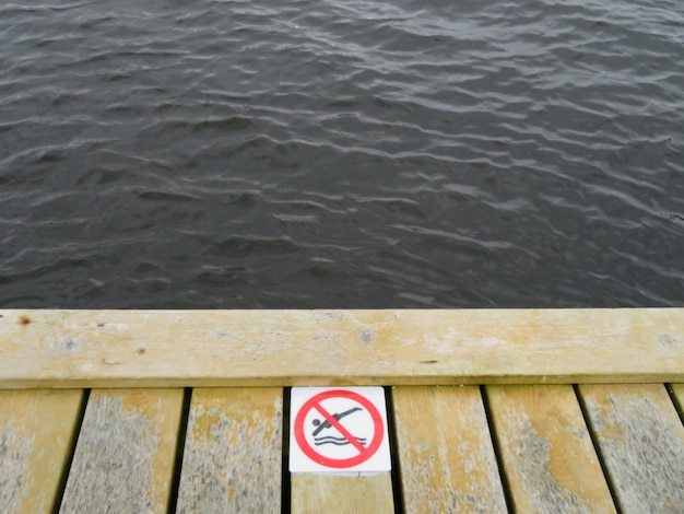 Photo close-up of text on wood by river