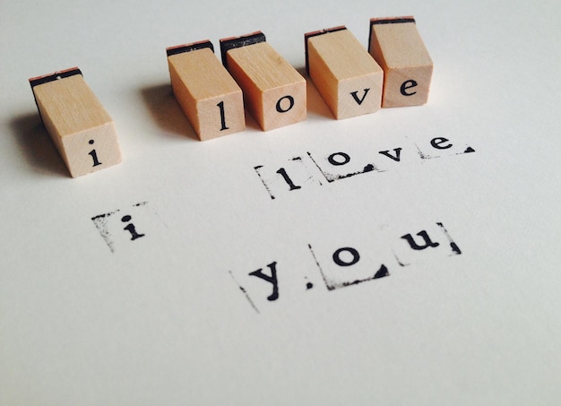 Photo close-up of text on wooden blocks over white background