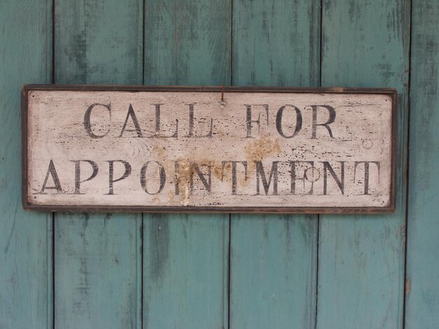 Photo close-up of text on wooden door