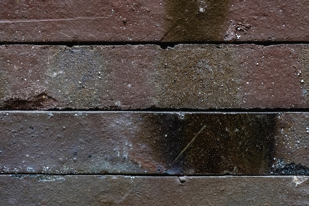 Close-up texture of a brown decorative scratched brick with a gap