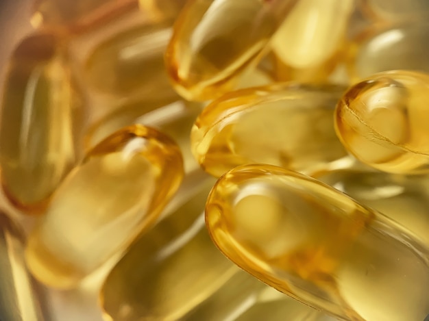 Close-up texture of many omega 3 capsules. Polyunsaturated fatty acids. The concept of a healthy lifestyle.