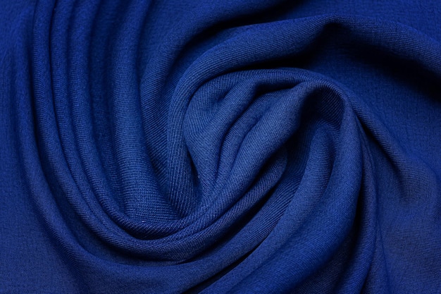 Close-up texture of natural blue fabric or cloth in tidewater color. Fabric texture of natural cotton or linen textile material. Blue or green canvas background.