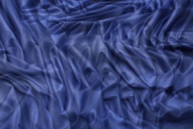 Close-up texture of natural blue fabric or cloth in tidewater color. Fabric texture of natural cotton or linen textile material. Blue or green canvas background.