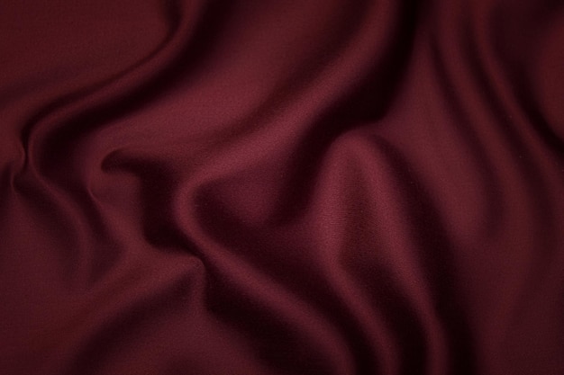 Close-up texture of natural red or pink or orange  fabric or cloth in same color. Fabric texture of natural cotton, silk or wool, or linen textile material. Red and orange canvas background.