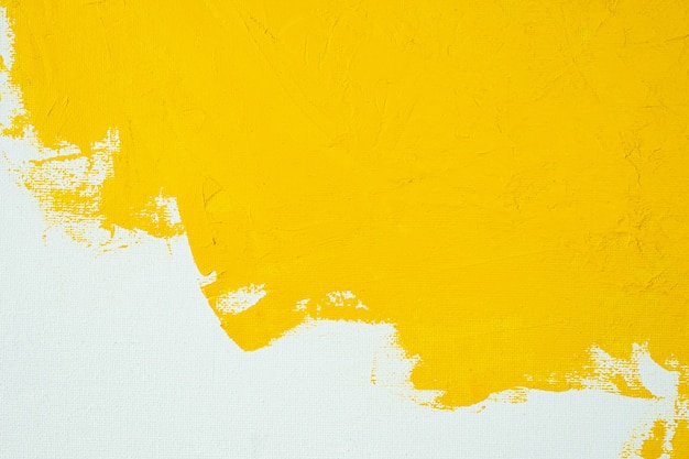 Close up Texture Yellow color paint on white colour canvas Brush marks stroke background