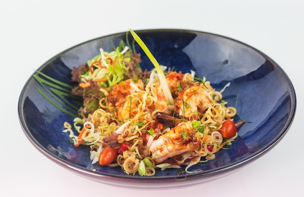 Close up Thai Cuisine shrimp salad with lemongrass in blue plate on white background