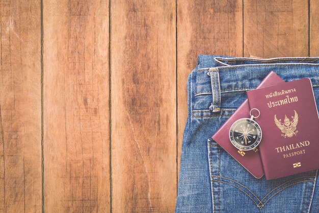 Close up Thailand passport and compass on wood