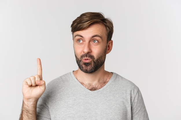 Close-up of thoughtful bearded man in gray t-shirt