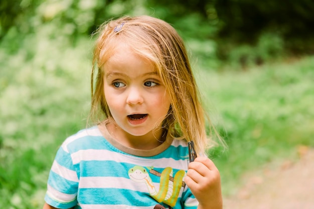 close-up of thoughtful girl standing against plants
