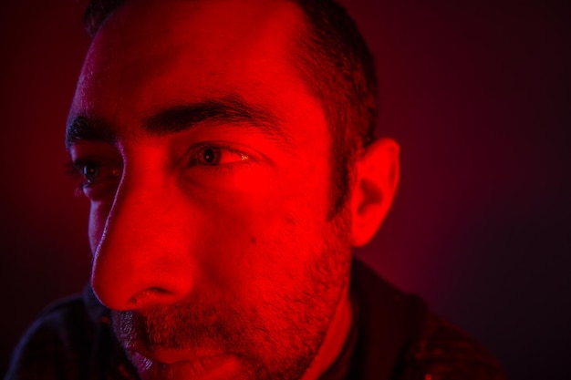 Close-up of thoughtful man against colored background