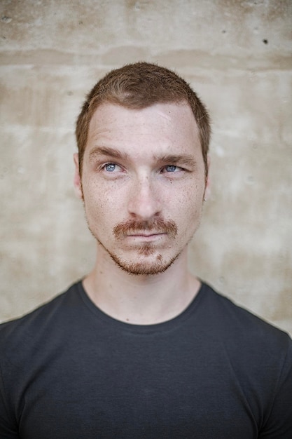 Close-up of thoughtful man against wall