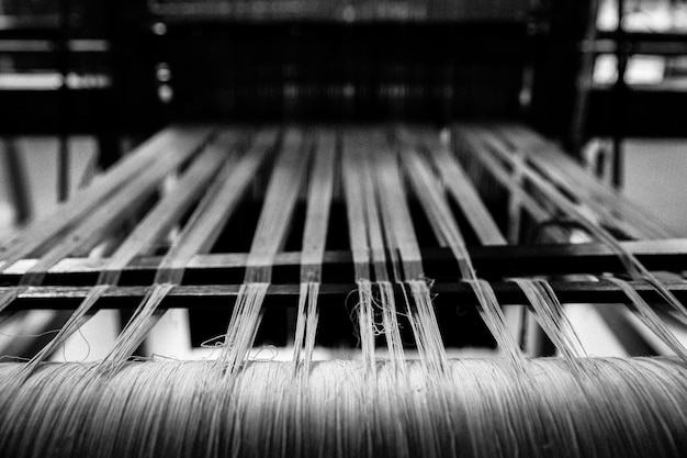 Photo close-up of thread weaving in loom