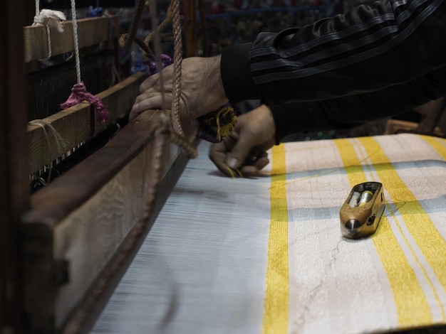 Close up of the threads in a wooden loom in a textile store in Fes, Morocco