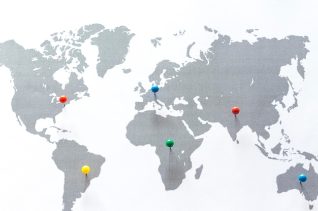 close-up of thumbtacks on world map