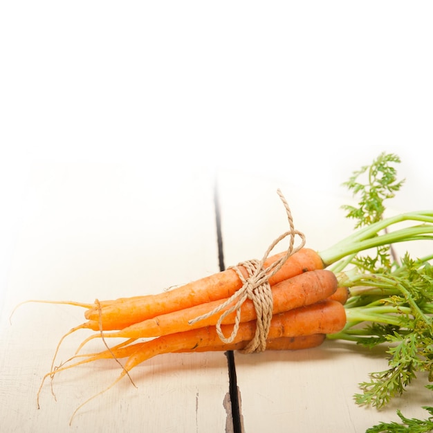 Close-up of tied up carrots on table