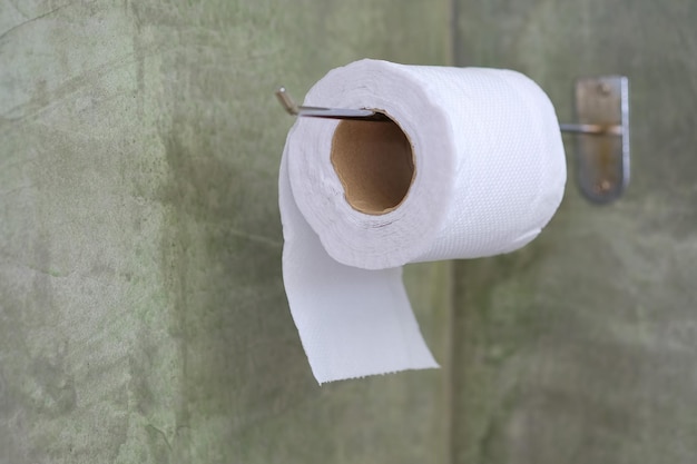 Photo close-up of tissue papers hanging on wall