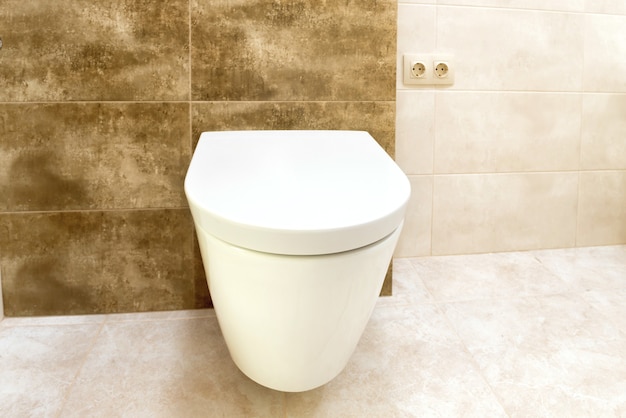 Close up of toilet bathroom interior with white ceramic seat