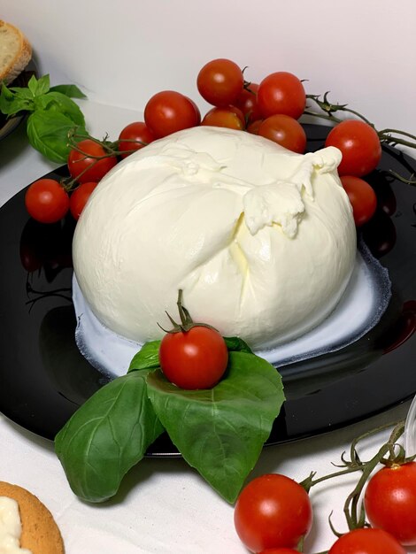 Close-up of tomatoes by food in plate on table