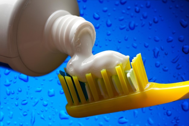 Close-up of toothpaste falling on brush