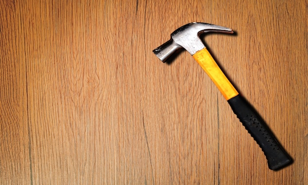 Close up top view of yellow hammer on wooden background