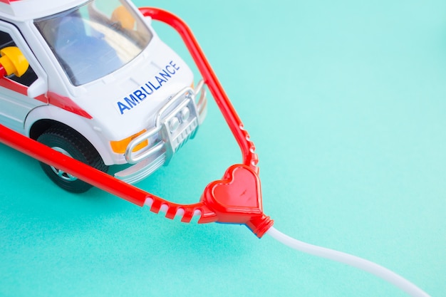 Close up of the toy ambulance on blue background.