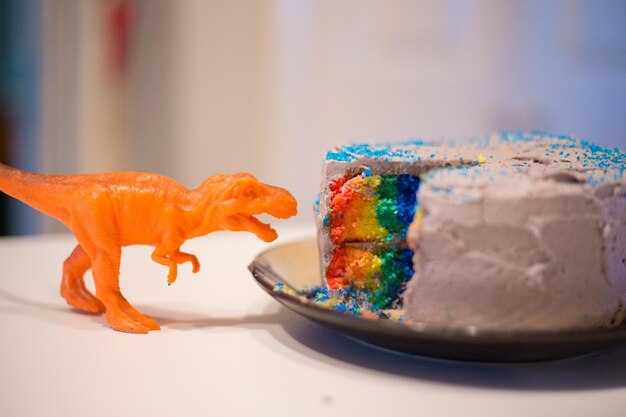 Close-up of toy and cake in plate on table