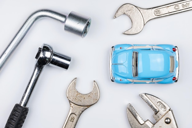 Photo close-up of toy car with work tools on white background