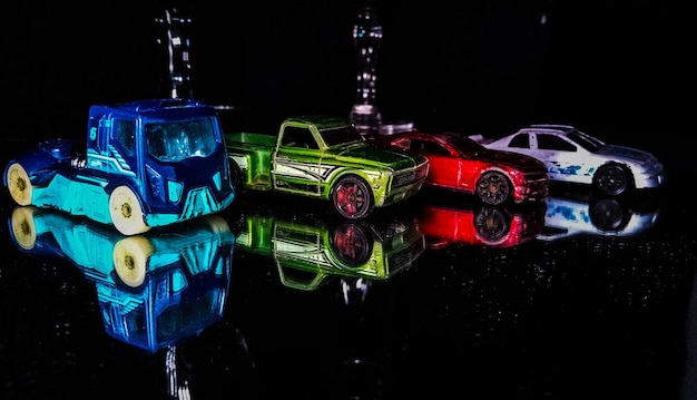 Photo close-up of toy cars against black background