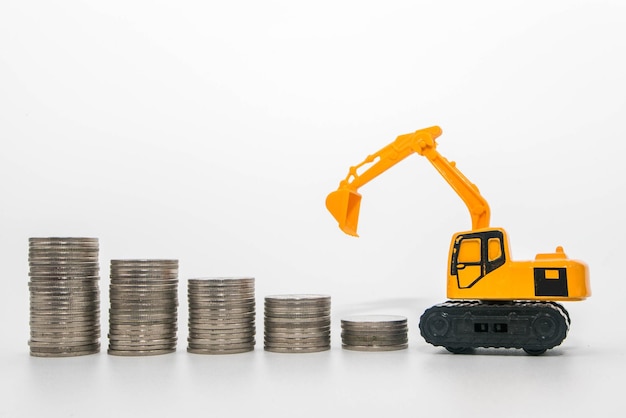 Close-up of toy and coins against white background